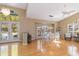 Bright dining room with large windows, hardwood floors, and modern light fixtures at 6905 Arbor Oaks Ct, Bradenton, FL 34209