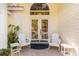 Inviting front entrance featuring double doors, decorative transom window, and cozy seating area at 6905 Arbor Oaks Ct, Bradenton, FL 34209