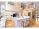 Open kitchen with island and breakfast bar, stainless steel appliances, loft, and views of the foyer and staircase at 6905 Arbor Oaks Ct, Bradenton, FL 34209