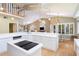 Open kitchen with vaulted ceilings, island cooktop, and plenty of countertop space at 6905 Arbor Oaks Ct, Bradenton, FL 34209