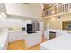 Spacious kitchen with white cabinetry, modern appliances, and an island with cooktop at 6905 Arbor Oaks Ct, Bradenton, FL 34209
