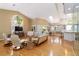 Spacious living room with cathedral ceilings, skylight, hardwood floors, and large windows at 6905 Arbor Oaks Ct, Bradenton, FL 34209