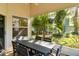 Relaxing covered patio area with plenty of seating and lush greenery at 6905 Arbor Oaks Ct, Bradenton, FL 34209