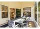 Covered porch with a dining table and chairs with views of the backyard at 6905 Arbor Oaks Ct, Bradenton, FL 34209