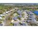 Scenic aerial of single-story homes with manicured lawns and mature landscaping, pool, shrubs, and garages at 6907 Stoneywalk Ct, Bradenton, FL 34203