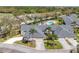 Aerial view of well-maintained single-story home and manicured lawn, pool, shrubs, and a two-car garage at 6907 Stoneywalk Ct, Bradenton, FL 34203