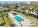 Aerial view of community pool and lounge area surrounded by lush landscaping and residential streets at 6907 Stoneywalk Ct, Bradenton, FL 34203