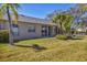 A well maintained backyard with lush green grass and landscaping, and sliding glass doors at 6907 Stoneywalk Ct, Bradenton, FL 34203