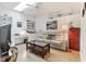 Inviting bonus room with a couch, desk, and a glass coffee table at 6907 Stoneywalk Ct, Bradenton, FL 34203