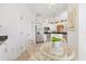 The dining area features a glass table, chairs, tile floors, and stainless steel appliances at 6907 Stoneywalk Ct, Bradenton, FL 34203