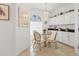 The dining area features tile flooring, white cabinets, and a glass table with chairs at 6907 Stoneywalk Ct, Bradenton, FL 34203