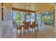 Inviting dining room with neutral tile flooring and large windows to the exterior that fills the space with light at 6907 Stoneywalk Ct, Bradenton, FL 34203