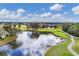 Aerial view of the golf course with a tranquil lake and luxurious homes at 6907 Stoneywalk Ct, Bradenton, FL 34203