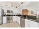 The kitchen features stainless steel appliances, white cabinets, and dark granite countertops at 6907 Stoneywalk Ct, Bradenton, FL 34203