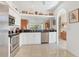 The kitchen features stainless steel appliances, white cabinets, and dark granite countertops at 6907 Stoneywalk Ct, Bradenton, FL 34203