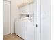 Bright laundry room featuring a full-size washer and dryer with ample storage above at 6907 Stoneywalk Ct, Bradenton, FL 34203