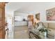 Bright living room featuring tile floors, a glass coffee table, and views of the entryway and kitchen at 6907 Stoneywalk Ct, Bradenton, FL 34203