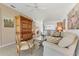 Bright living room featuring tile floors, a large wood cabinet, and views of the entry and kitchen at 6907 Stoneywalk Ct, Bradenton, FL 34203