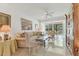 Bright and airy living room featuring tile flooring, neutral decor, and a view of the backyard at 6907 Stoneywalk Ct, Bradenton, FL 34203