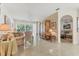 Open-concept living area with tiled floors, a ceiling fan, and sliders to the lanai at 6907 Stoneywalk Ct, Bradenton, FL 34203