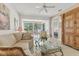 Bright living room featuring a ceiling fan, tile floors, and views of the dining area and Primary bedroom at 6907 Stoneywalk Ct, Bradenton, FL 34203
