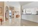 Open floor plan features tile flooring with archways to the bedroom and kitchen areas at 6907 Stoneywalk Ct, Bradenton, FL 34203
