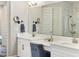 Bright bathroom featuring a double sink vanity, updated fixtures, and walk-in shower at 6913 Neopolitan Ct, Apollo Beach, FL 33572