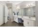 Contemporary bathroom featuring double sinks, updated fixtures, and a walk-in shower at 6913 Neopolitan Ct, Apollo Beach, FL 33572