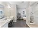 Modern bathroom with dual vanities, soaking tub, and walk-in shower at 6913 Neopolitan Ct, Apollo Beach, FL 33572