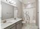 Bright bathroom features a double vanity and a bathtub with a unique bicycle-themed shower curtain, adding character at 6913 Neopolitan Ct, Apollo Beach, FL 33572