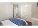Bedroom with white closet doors and an open doorway to the bathroom, creating a sense of flow and convenience at 6913 Neopolitan Ct, Apollo Beach, FL 33572