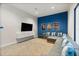 Comfortable media room featuring a large sectional sofa and wall-mounted TV for immersive entertainment at 6913 Neopolitan Ct, Apollo Beach, FL 33572