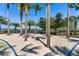 Outdoor sand volleyball court with towering palm trees for shaded comfort and enhanced community recreation at 6913 Neopolitan Ct, Apollo Beach, FL 33572