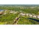 Aerial view of a home with pond views, beautiful greenery, and surrounding landscape at 7004 Old Tabby Cir, Lakewood Ranch, FL 34202