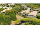 Aerial shot of a home with a screened lanai, surrounded by lush landscaping and pond views at 7004 Old Tabby Cir, Lakewood Ranch, FL 34202