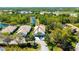 An aerial view of a home with a tile roof, tropical landscaping, and a serene waterway in the background at 7004 Old Tabby Cir, Lakewood Ranch, FL 34202