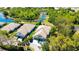 Aerial view of homes with well-manicured lawns, close to a scenic pond and mature trees at 7004 Old Tabby Cir, Lakewood Ranch, FL 34202
