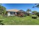 Backyard featuring a screen-enclosed patio and landscaped greenery at 7004 Old Tabby Cir, Lakewood Ranch, FL 34202