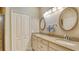 Bathroom features a double vanity with granite countertop, oval mirrors, and a closet at 7004 Old Tabby Cir, Lakewood Ranch, FL 34202
