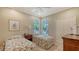 Bedroom with two twin beds, ceiling fan, and windows providing natural light at 7004 Old Tabby Cir, Lakewood Ranch, FL 34202
