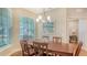 Dining room with hardwood flooring, large window and a beach-themed painting on the wall at 7004 Old Tabby Cir, Lakewood Ranch, FL 34202