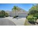 Exterior of a home featuring a well-maintained driveway, lush landscaping, and a two-car garage at 7004 Old Tabby Cir, Lakewood Ranch, FL 34202