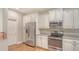 Bright kitchen with stainless appliances, granite counters, and ample storage space at 7004 Old Tabby Cir, Lakewood Ranch, FL 34202