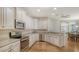 Kitchen with granite counters, stainless appliances and white cabinets at 7004 Old Tabby Cir, Lakewood Ranch, FL 34202