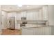 Kitchen features white cabinets, granite countertops and stainless steel appliances at 7004 Old Tabby Cir, Lakewood Ranch, FL 34202