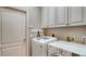 Laundry room featuring a washer, dryer, and plenty of storage space at 7004 Old Tabby Cir, Lakewood Ranch, FL 34202