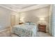 Spacious main bedroom with tray ceiling, carpet flooring and ensuite bathroom access at 7004 Old Tabby Cir, Lakewood Ranch, FL 34202