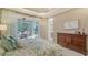 Main bedroom with a king bed and screened outdoor porch access at 7004 Old Tabby Cir, Lakewood Ranch, FL 34202