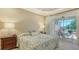 Main bedroom with a king bed and access to screened outdoor porch at 7004 Old Tabby Cir, Lakewood Ranch, FL 34202