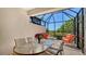Screened patio showcasing comfortable seating and a view of the surrounding landscape at 7004 Old Tabby Cir, Lakewood Ranch, FL 34202